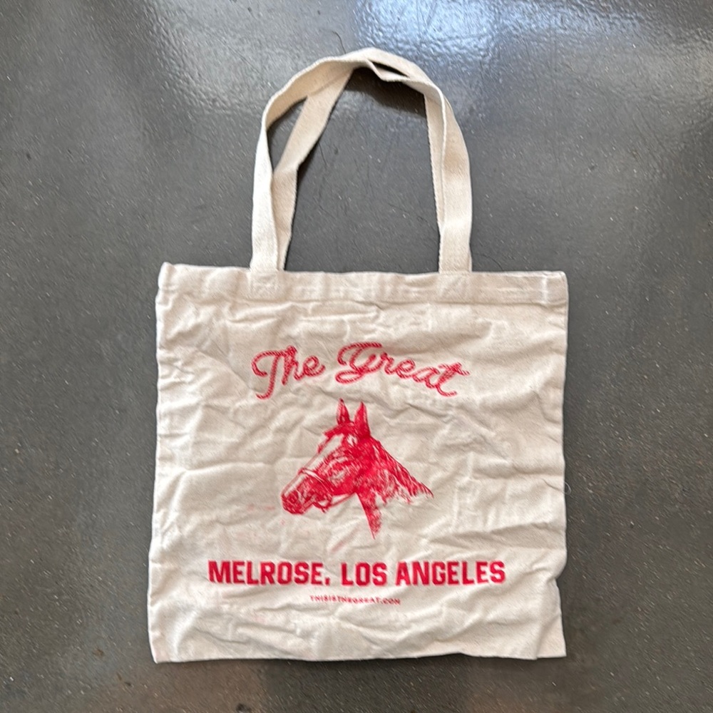 THE GREAT. Cream Tote with Red Horse Graphic
